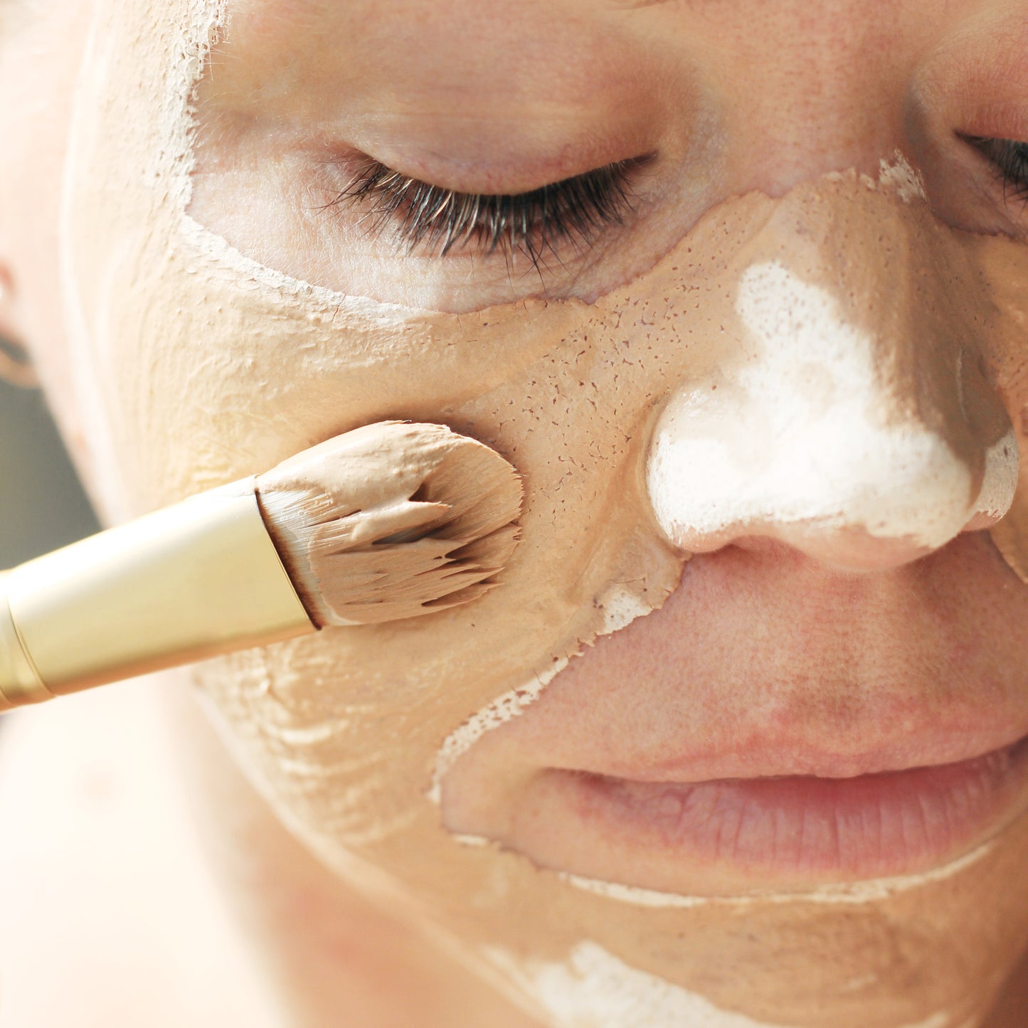 French Nude Clay Mask being applied to womens facial skin